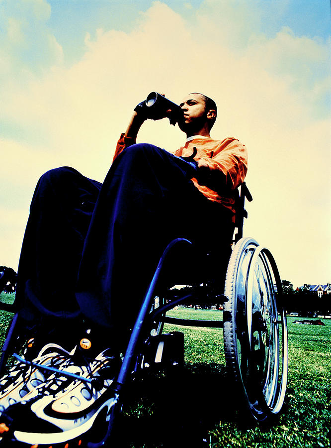 Man In Wheelchair Drinking By Michael Donne Science Photo Library