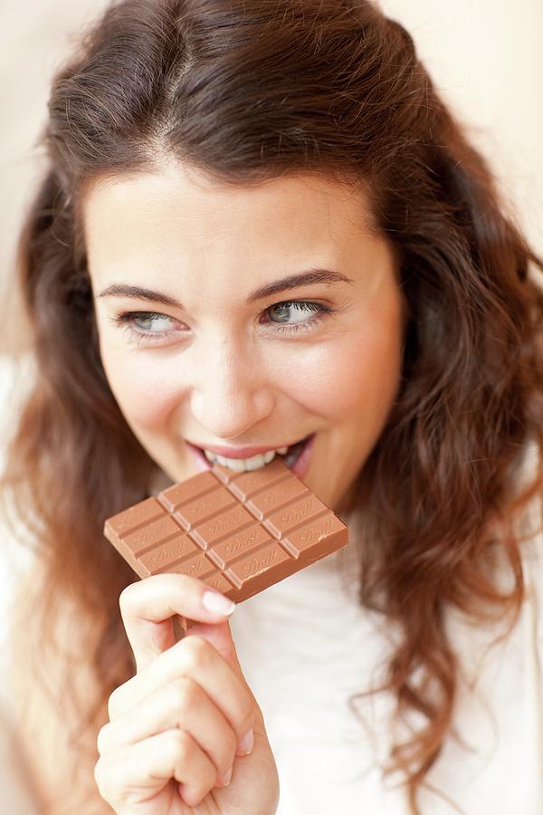 Woman Eating Chocolate Photograph By Ian Hooton Science Photo Library