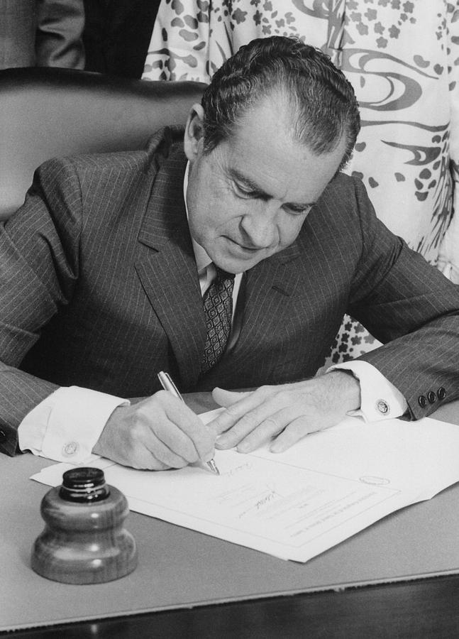 Richard Nixon Signing A Bill Into Law Photograph by Everett