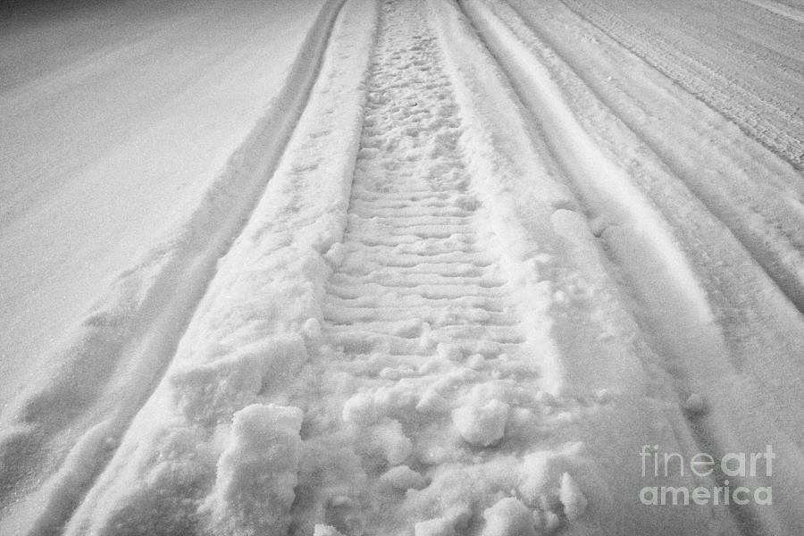 snowmobile tracks in snow in rural Saskatchewan Canada