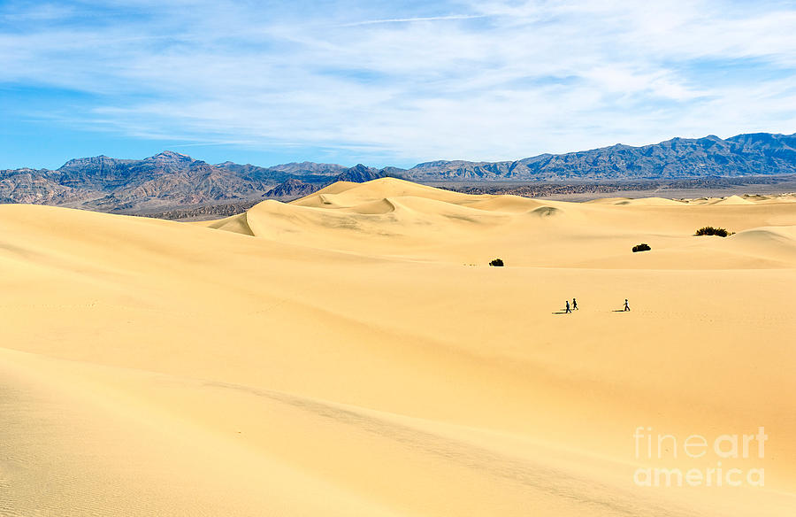 Walking In The Sand Dunes In California Travelers Three Walking Across The Sand Dunes In