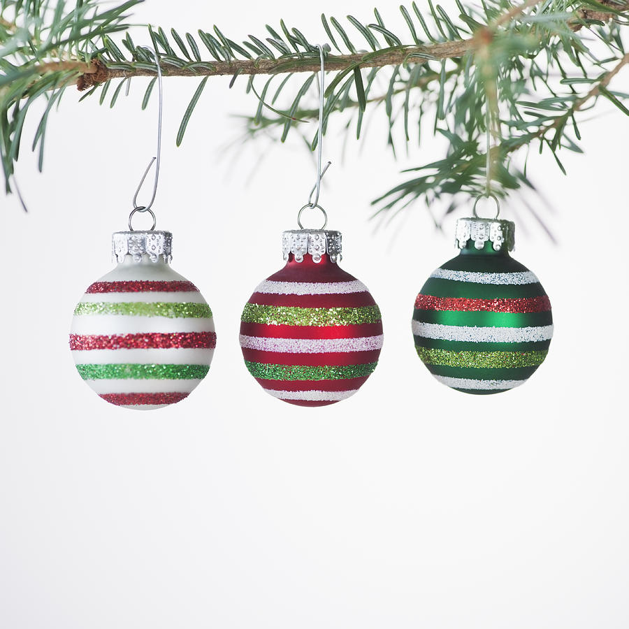 studio shot of striped christmas ornaments hanging on studio shot of striped christmas ornaments hanging on