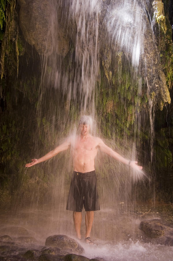 a-man-enjoys-a-shower-under-a-waterfall-taylor-s-kennedy.jpg