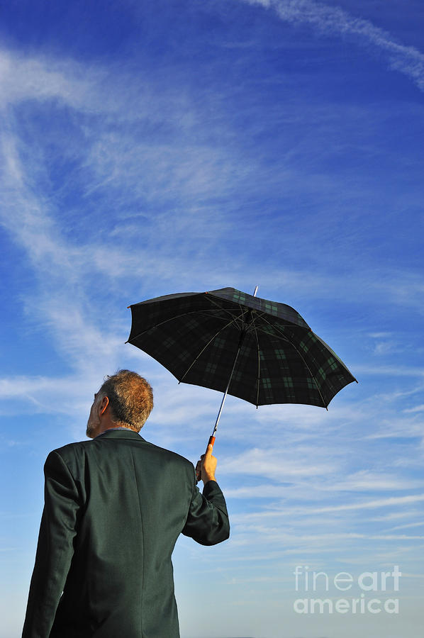 businessman-looking-at-sky-holding-umbrella-sami-sarkis.jpg