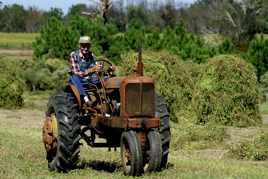 Old Farmer In Field On Tractor by Danny Jones