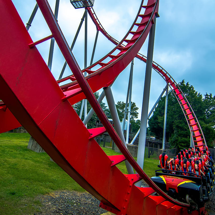 crazy-rollercoaster-rides-at-amusement-park-photograph-by-alex-grichenko