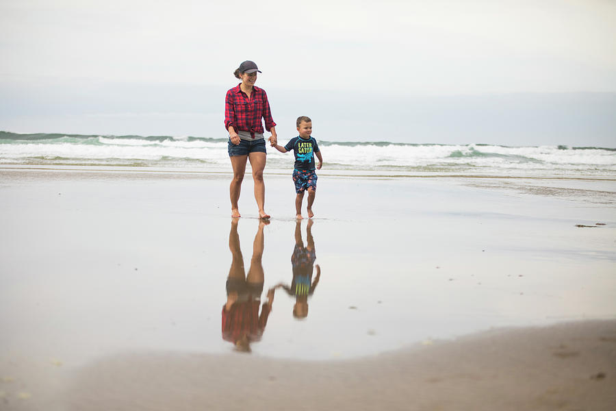 Mother Walking On Beach Holding Hands With Her Son Photograph By