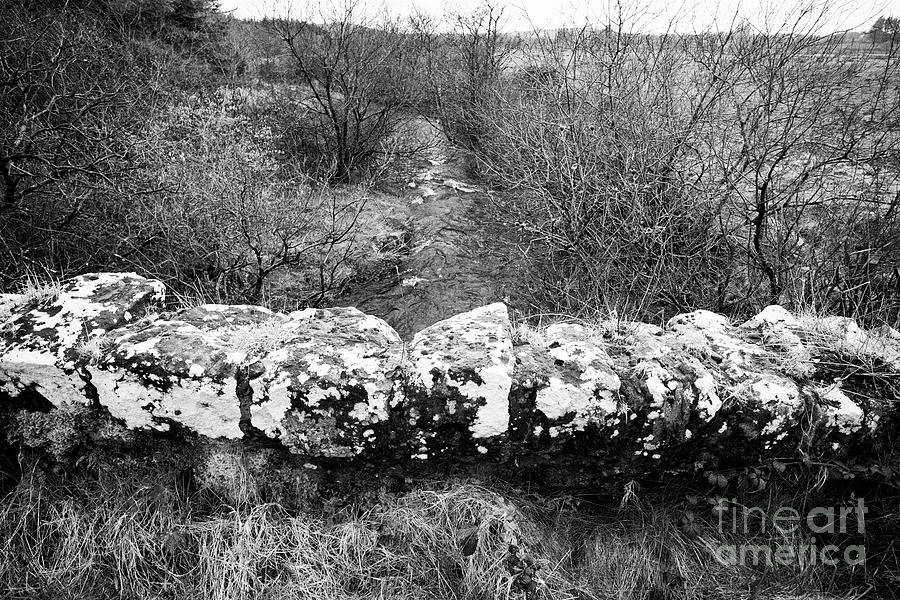 Old Stone Bridge Over Small Stream River In Flood In Remote Rural