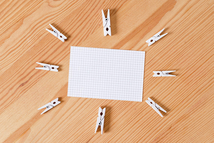 White Clothespin Spread In Circles Pointing To An Empty Rectangle