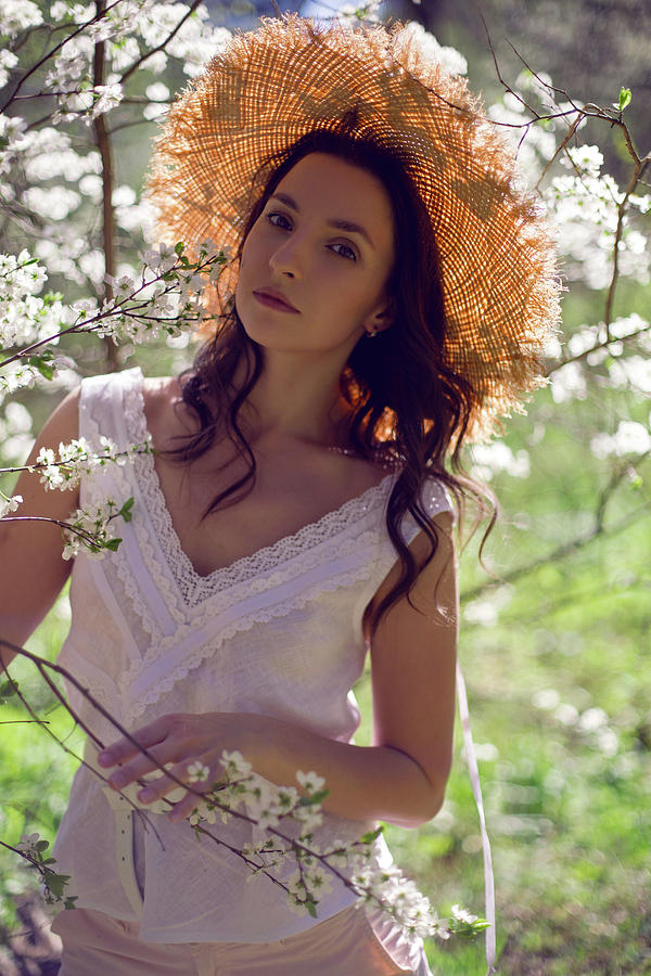 Beautiful Brunette Woman Stands In A Blooming Apple Orchard Photograph