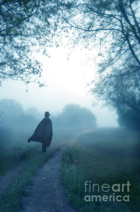 Man In Top Hat And Cape On Foggy Dirt Road by Jill Battaglia