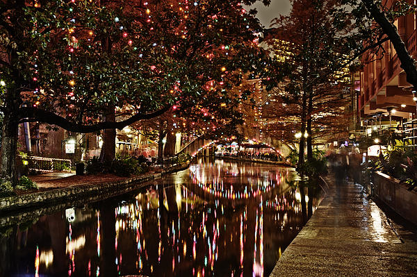 Alan Tonnesen - San Antonio riverwalk decorated with shiny lights at night refle