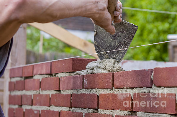 https://images.fineartamerica.com/images-medium-5/trowel-spreading-cement-on-bricks-patricia-hofmeester.jpg