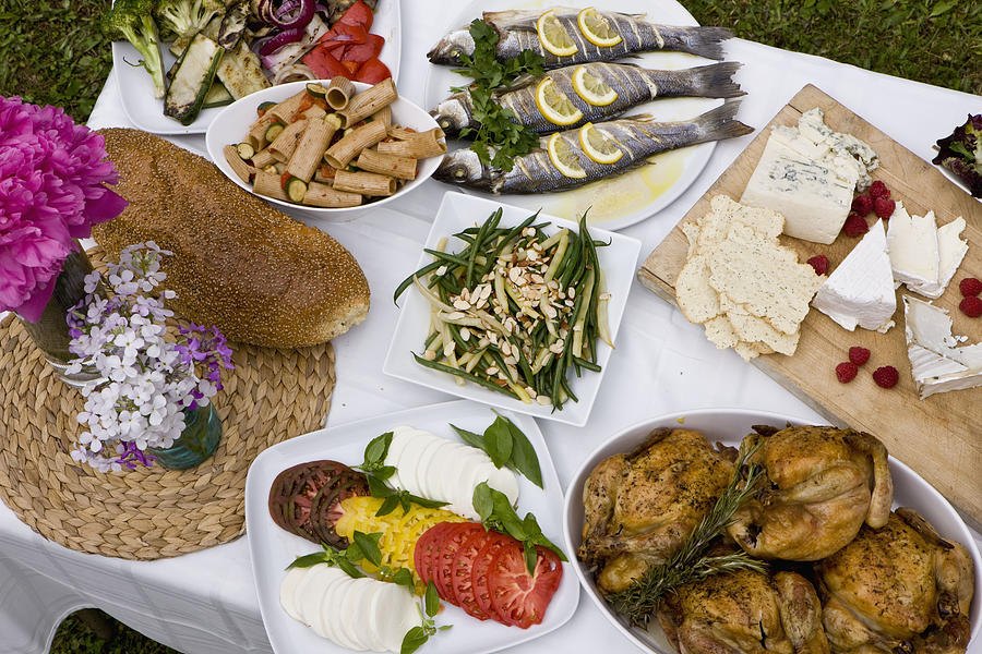  Food at outdoor dinner party in countryside Photograph by Thomas Jackson