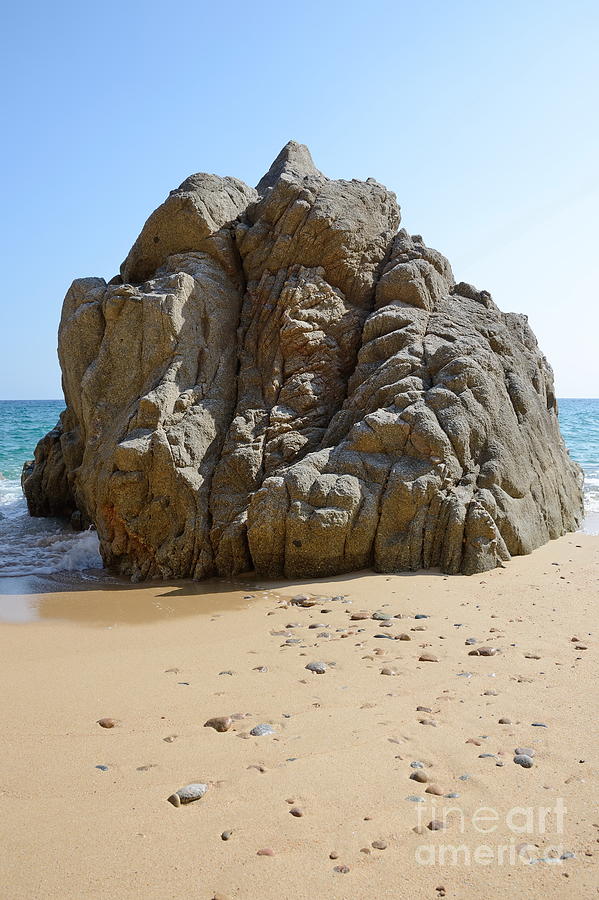 Holiday Photograph -  single rock on the sandy beach of the Costa Brava by Karin Stein