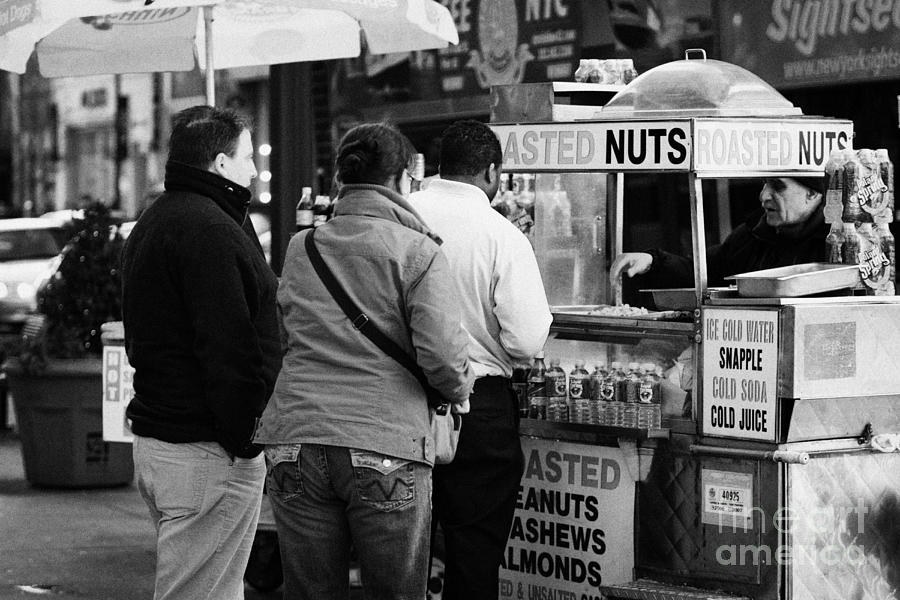 Winter Photograph -  Vendor Selling Roasted Nuts And Soft Drinks To Queue Of  People New York City by Joe Fox