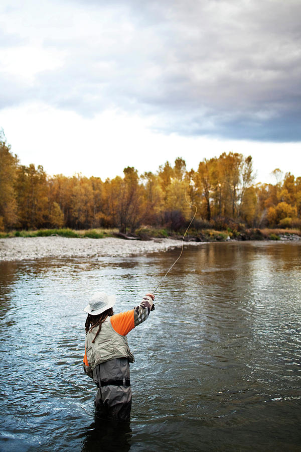 Fall Photograph - A Athletic Man Fly Fishing Stands #1 by Patrick Orton