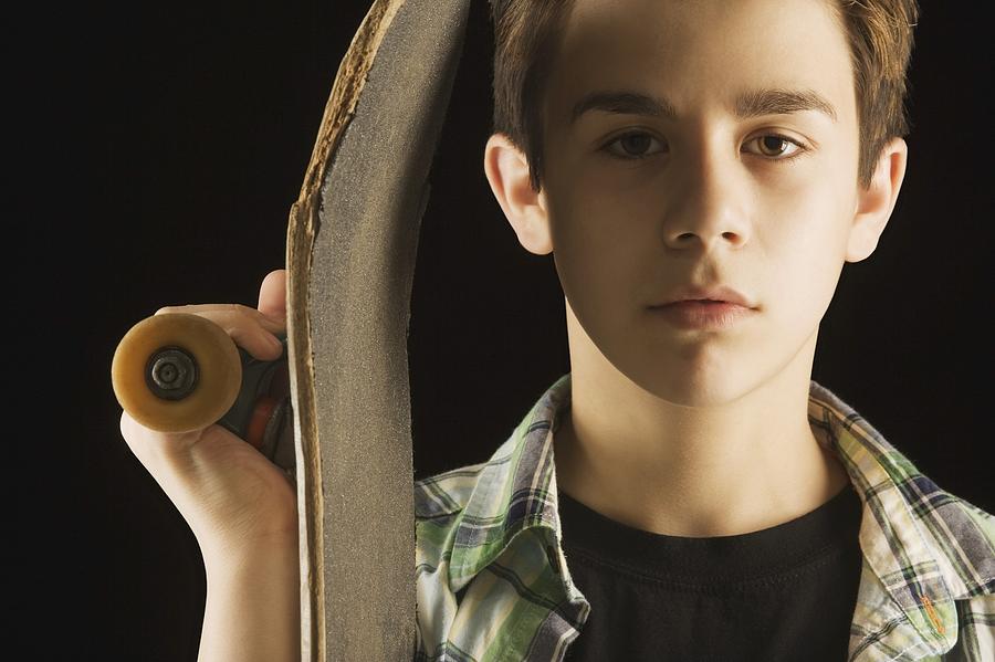 A Boy With A Skateboard Photograph