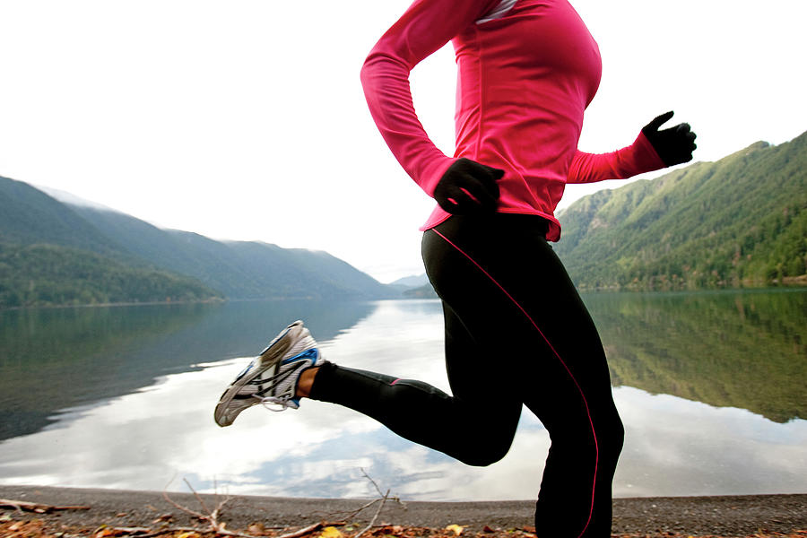 A Female Jogging Along The Lake Photograph By Jordan Siemens Fine Art