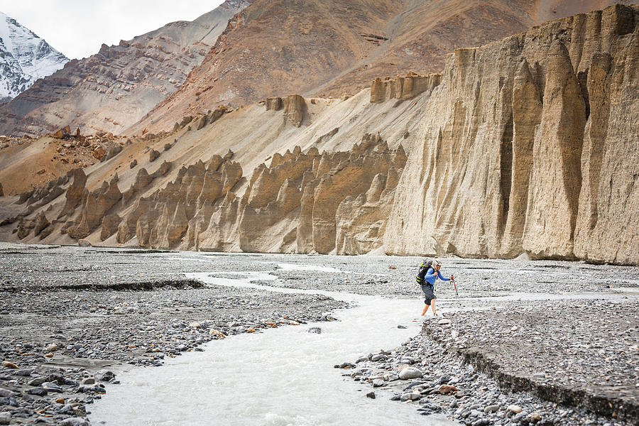 Nature Photograph - A Hiker Is Crossing A River, Spiti #1 by Andrew Peacock