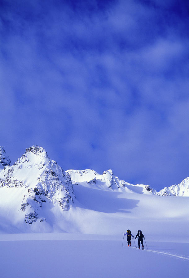 Adventure Photograph - A Man And Woman Ski Tour And Explore by Jimmy Chin Adventure Photograph - A Man And Woman Ski Tour And Explore by Jimmy Chin