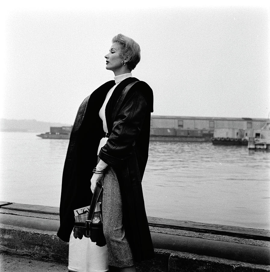A Model Standing On A Dock In A Leather Coat #1 Photograph by Richard Rutledge