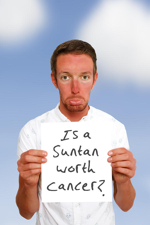 A sad man with sunburn holding up a sign Photograph by Tom And Steve A sad man with sunburn holding up a sign Photograph by Tom And Steve