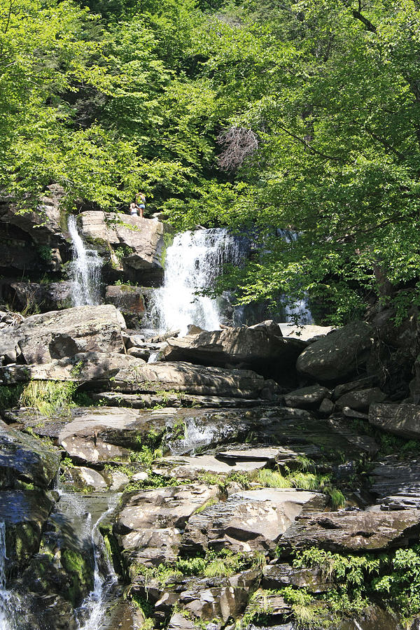 A View Of 2 People At The Top Of Bastion Falls Photograph