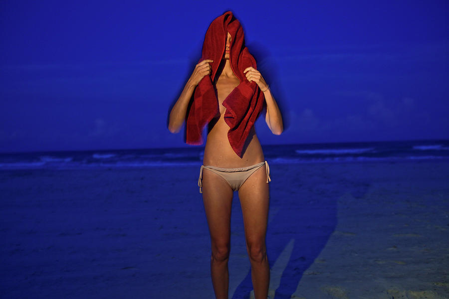 Nature Photograph - A Woman Going Topless Has A Red Towel #1 by Eyeconic Images