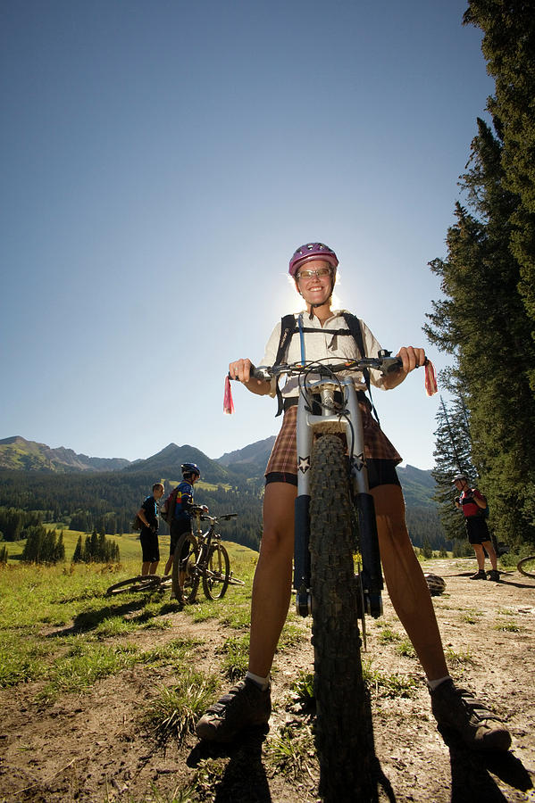 Athletic Female In Sports Attire Poses With Her Bike Against A Rugged  Terrain Photo Background And Picture For Free Download - Pngtree