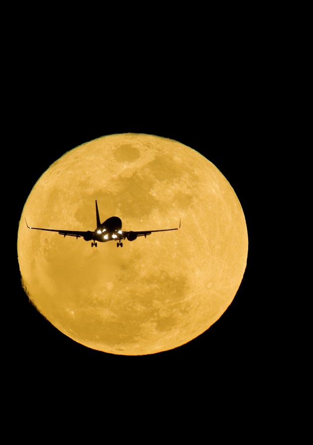 Aeroplane Silhouetted Against A Full Moon Photograph by David Nunuk