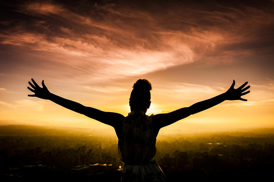African American Woman Raising Arms at Sunset #1 Photograph by Adamkaz