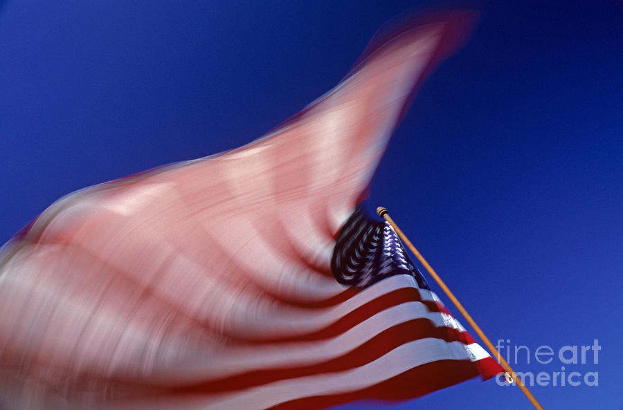 American Flag blurred waving in the wind  #1 Photograph by Jim Corwin
