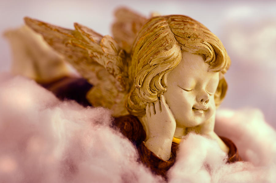 Angel resting on clouds and enjoying the sun #1 Photograph by U Schade