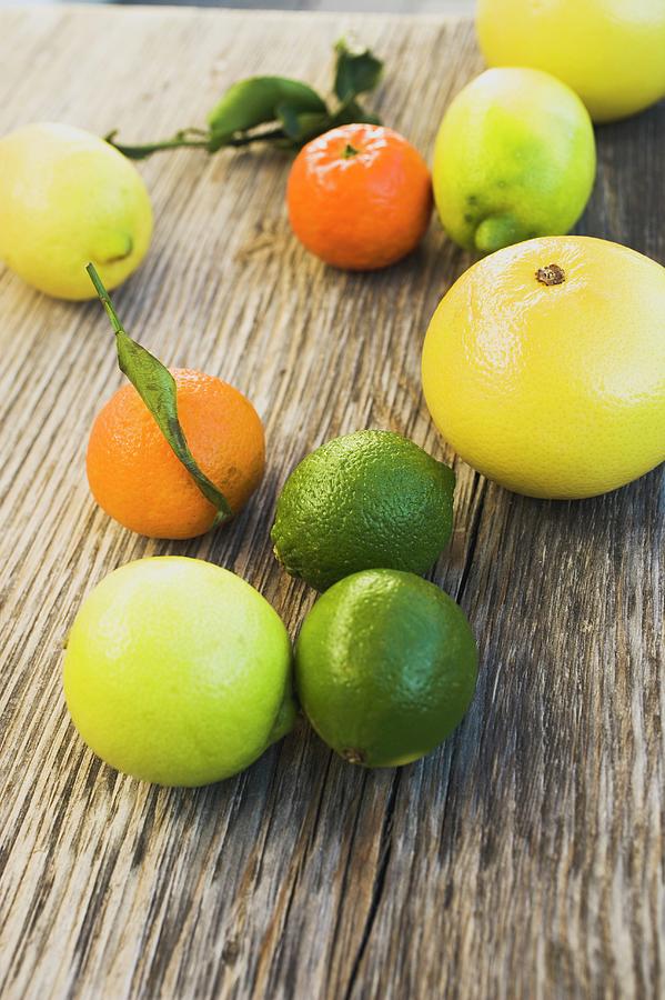 Still Life Photograph - Assorted Citrus Fruit On Wooden Background #1 by Foodcollection