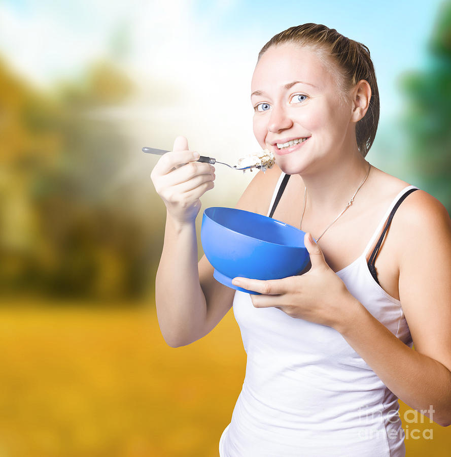 Attractive young blond woman eating oatmeal #1 Photograph by Jorgo Photography