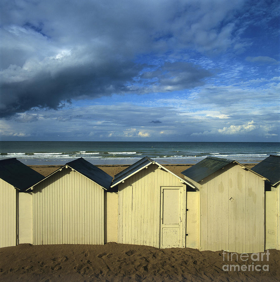Beach huts under a stormy sky in Normandy. France. Europe #1 Photograph by Bernard Jaubert
