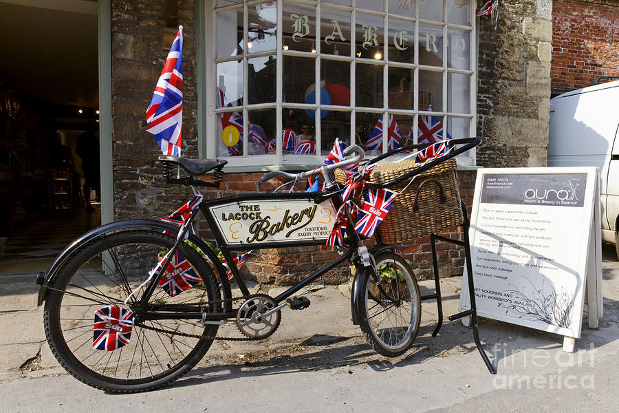 Bicycle outside Lacock Bakery in Lacock village Wiltshire England #1 Photograph by Robert Preston