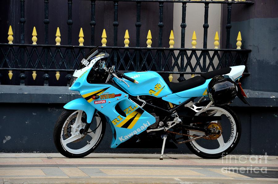 Blue yellow sporty motorcycle parked on pavement Singapore Photograph by Imran Ahmed