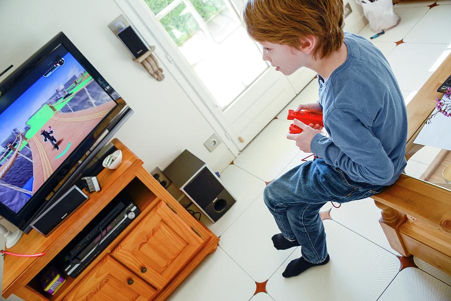 Boy Playing Wii Video Game #1 Photograph by Aj Photo