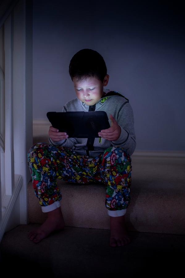 Movie Photograph - Boy Using A Digital Tablet In The Dark #1 by Samuel Ashfield