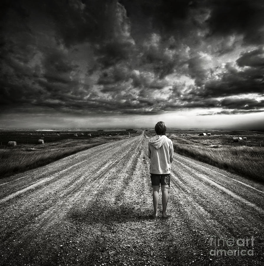 Boy walking on dark lonely road in early evening  #1 Photograph by Sandra Cunningham