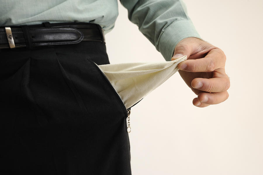 Businessman showing out an empty pants pocket #1 Photograph by Sami Sarkis