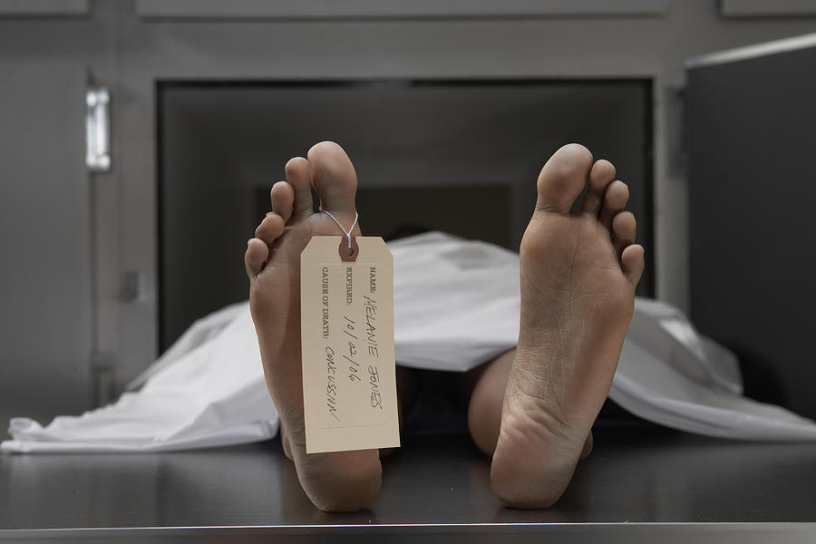 Cadaver on autopsy table, label tied to toe, close-up #1 Photograph by Darrin Klimek
