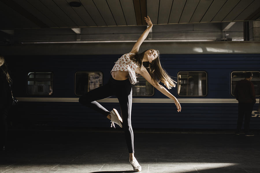 Caucasian woman dancing near train #1 Photograph by Aliaksandr Liulkovich