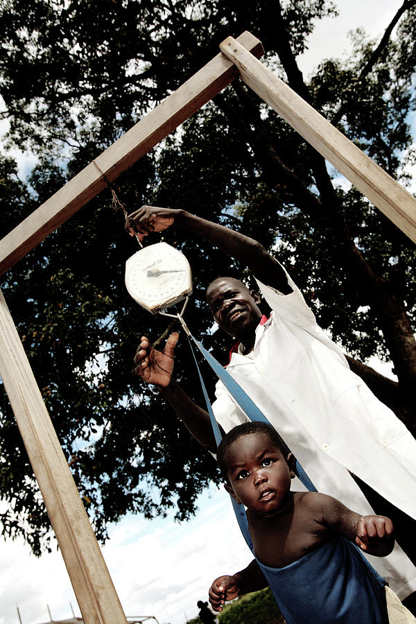 Child Being Weighed #1 Photograph by Mauro Fermariello/science Photo Library