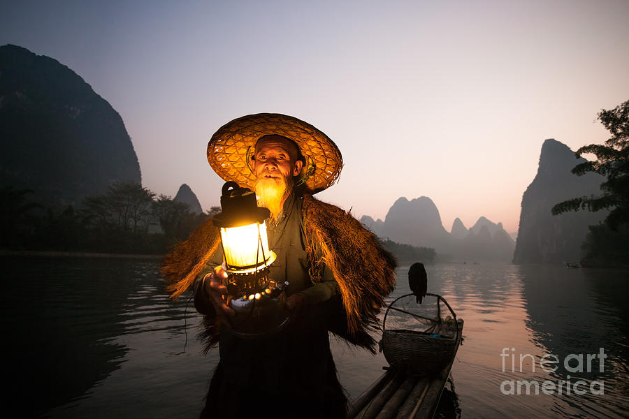 Chinese fisherman with lantern on boat near Guilin China #1 Photograph by Matteo Colombo