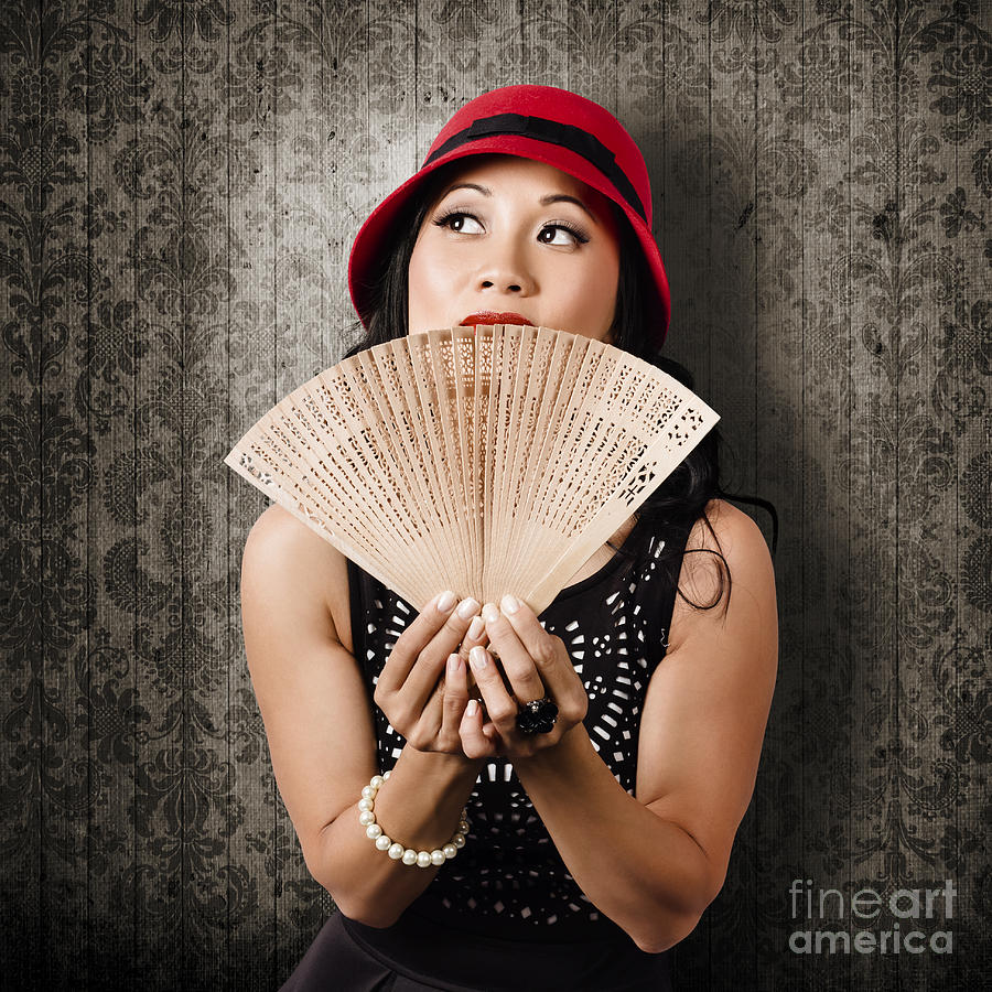 Chinese girl fanning herself with Asian hand fan Photograph by Jorgo