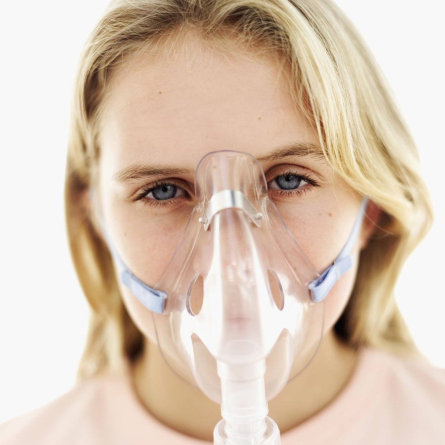 Close-up of a girl (11-13) wearing an oxygen mask #1 Photograph by Stockbyte