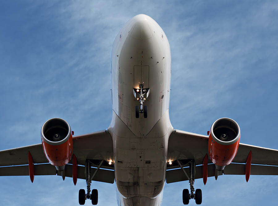 Close up of passenger plane landing overhead Photograph by Ken Biggs ...